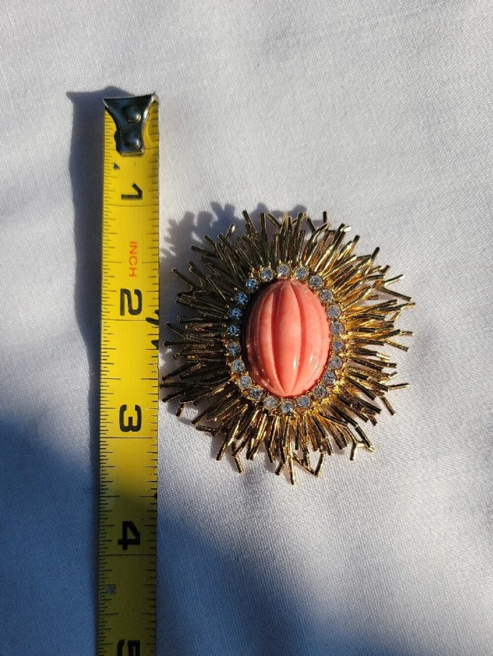 Vintage Joan Rivers Gold Sunburst Brooch with Coral Center